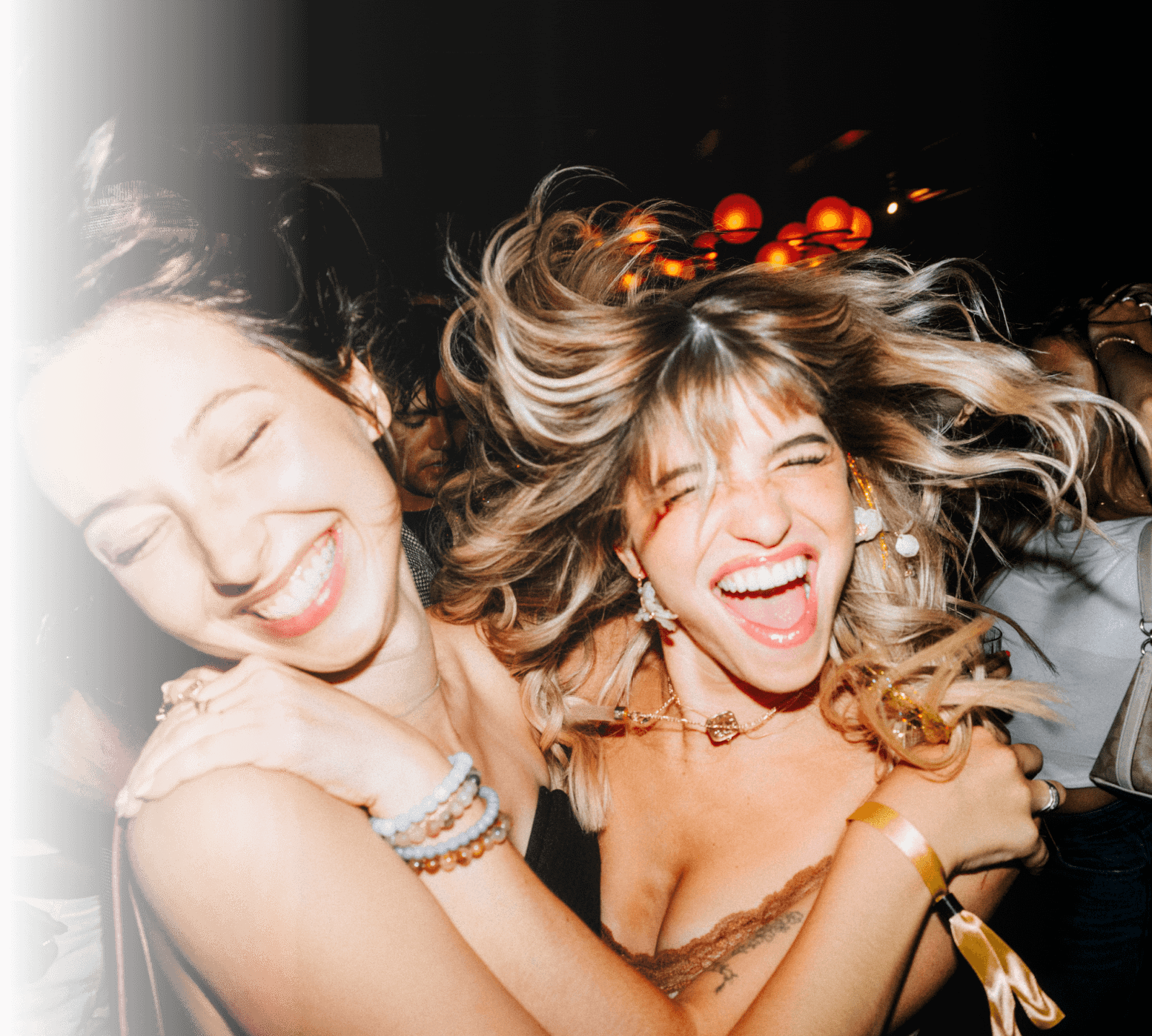 Two friends laughing at a party